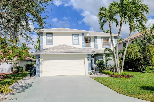 view of front of property with a front yard and a garage