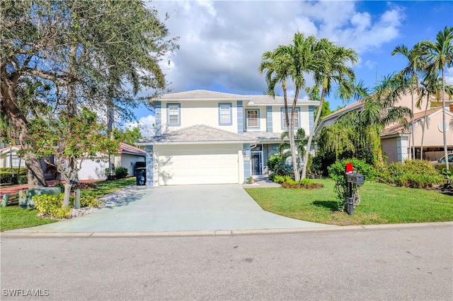 view of front of property featuring a front yard and a garage