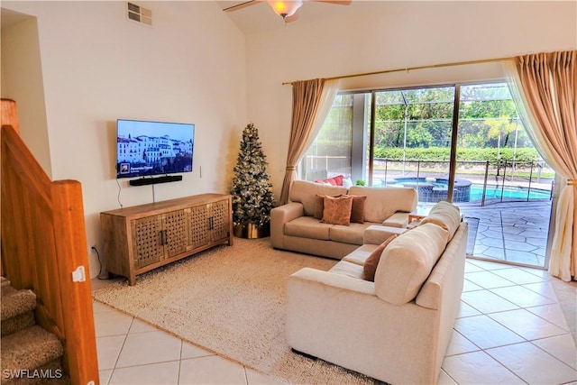 tiled living room with a towering ceiling and ceiling fan