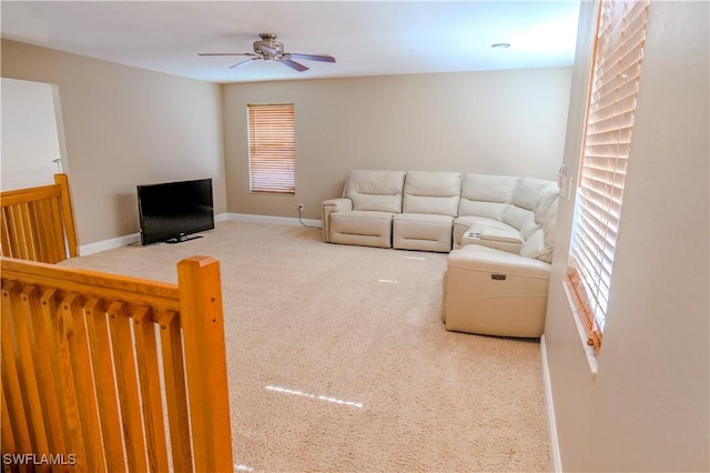 living room with ceiling fan and carpet floors