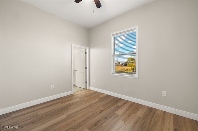 unfurnished room with hardwood / wood-style flooring and ceiling fan