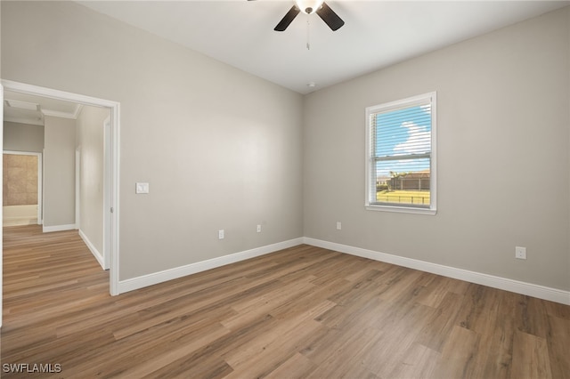 unfurnished room with ceiling fan, crown molding, and light hardwood / wood-style flooring