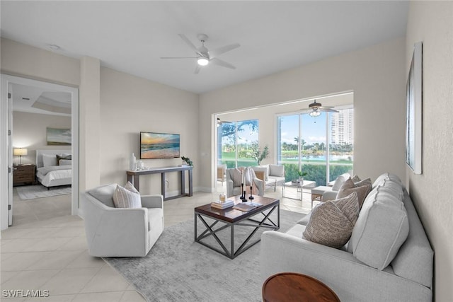 living room featuring ceiling fan and light tile patterned flooring