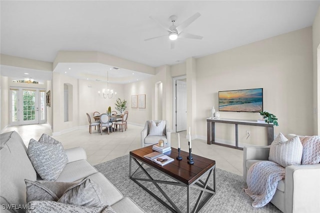 living room with french doors, light tile patterned flooring, and ceiling fan with notable chandelier