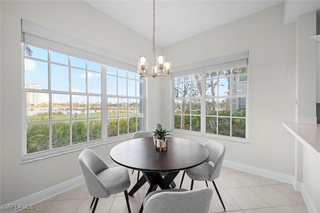 dining space featuring light tile patterned floors and a notable chandelier