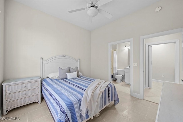 bedroom featuring ceiling fan, light tile patterned floors, and ensuite bathroom