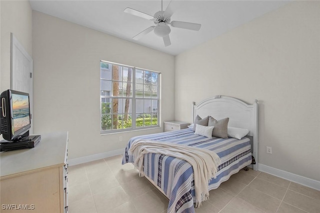 tiled bedroom featuring ceiling fan