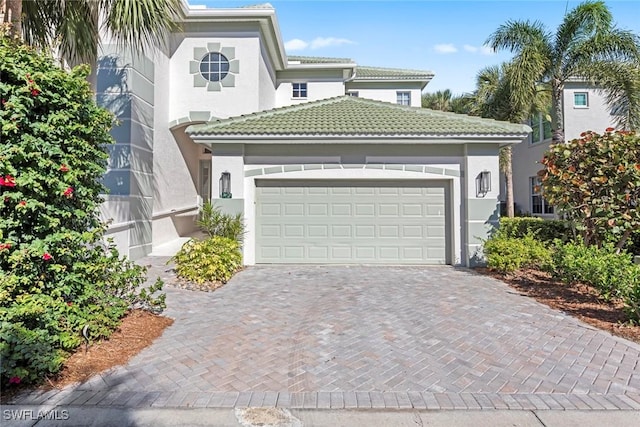 mediterranean / spanish-style home with a garage