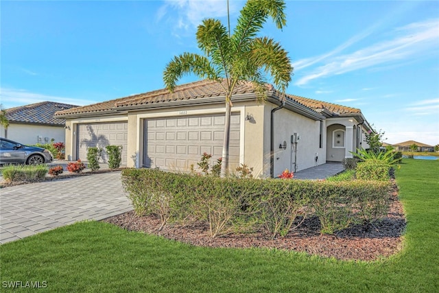 view of front of house with a front yard and a garage