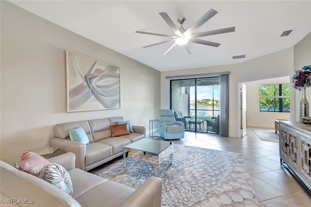 living room with ceiling fan and light tile patterned flooring