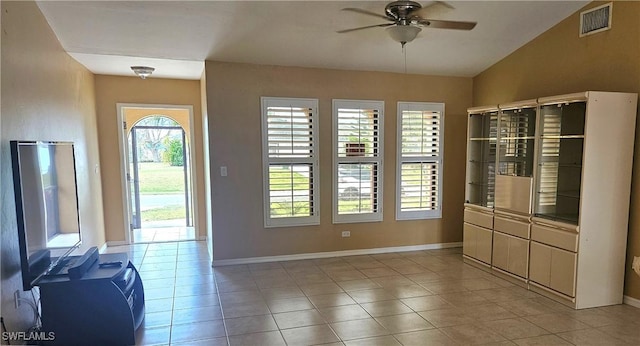 interior space with ceiling fan, light tile patterned flooring, and lofted ceiling