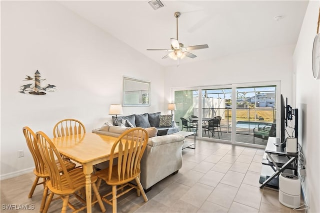 dining area featuring ceiling fan and high vaulted ceiling