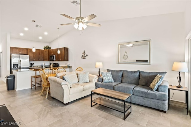 living room featuring ceiling fan and high vaulted ceiling