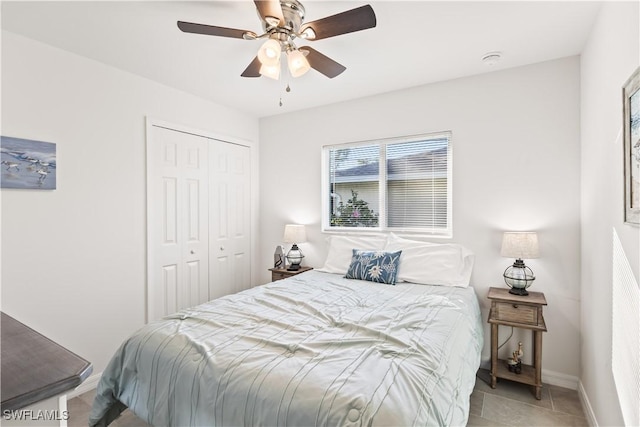 tiled bedroom featuring a closet and ceiling fan