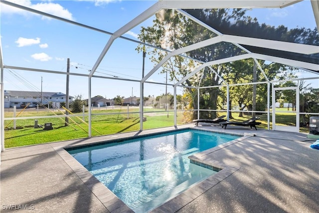 view of pool with a lanai, a yard, and a patio