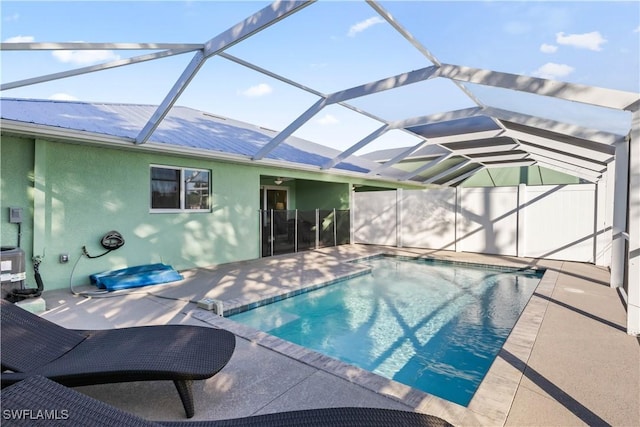 view of pool featuring a patio and glass enclosure