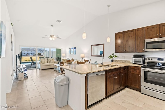 kitchen featuring hanging light fixtures, sink, ceiling fan, appliances with stainless steel finishes, and kitchen peninsula