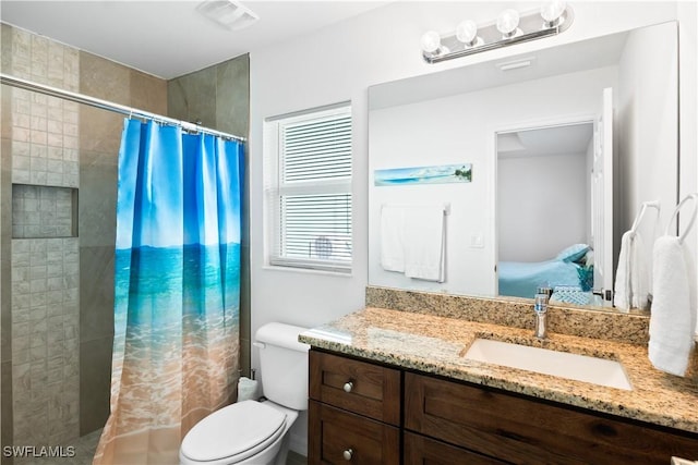 bathroom with vanity, a shower with shower curtain, and toilet