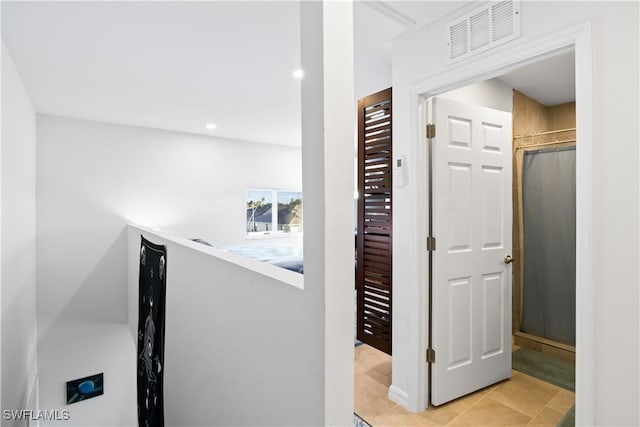 hallway with light tile patterned floors