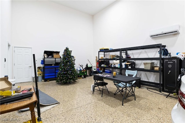 home office featuring a wall mounted air conditioner and a high ceiling