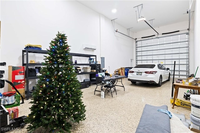 garage with a wall unit AC and electric panel