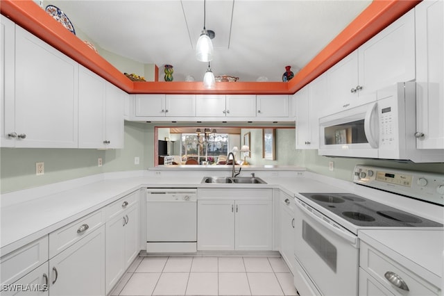 kitchen featuring sink, hanging light fixtures, light tile patterned floors, white appliances, and white cabinets