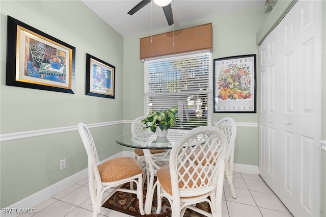 tiled dining room featuring ceiling fan