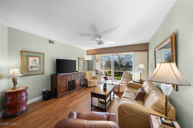 living room with hardwood / wood-style flooring and ceiling fan