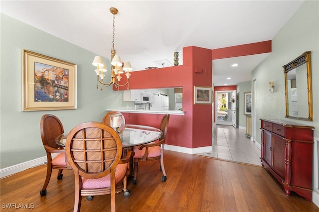 dining room featuring hardwood / wood-style floors and a notable chandelier