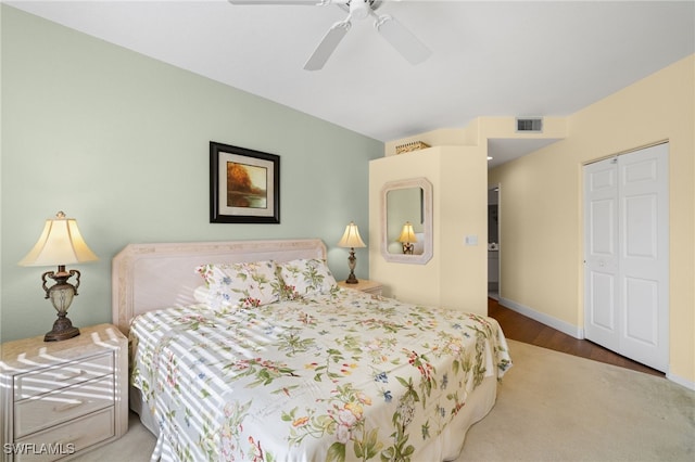 bedroom with wood-type flooring, ceiling fan, and a closet