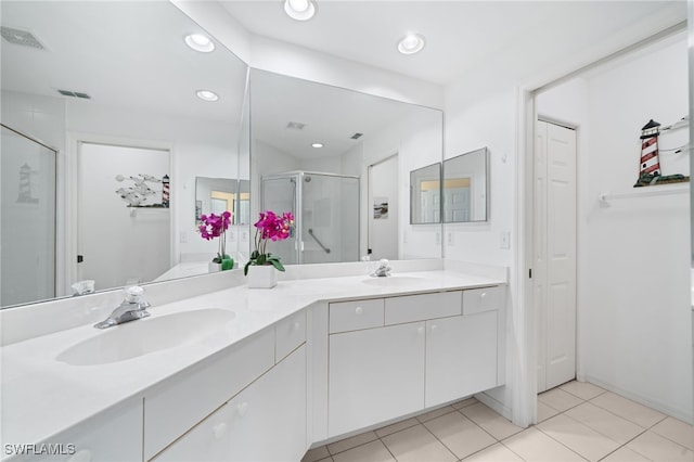 bathroom featuring walk in shower, tile patterned floors, and vanity