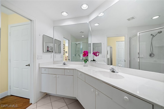 bathroom with vanity, tile patterned floors, and a shower with door