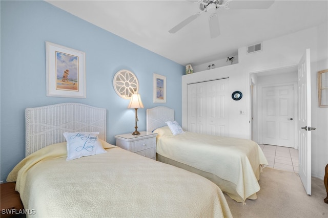 bedroom with light tile patterned floors, ceiling fan, and a closet