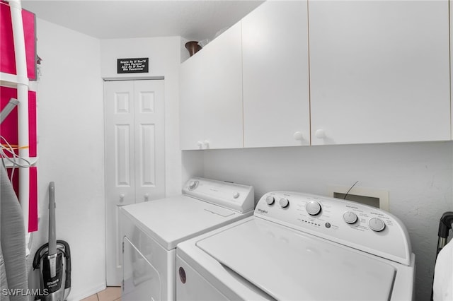 laundry room with cabinets and washer and dryer