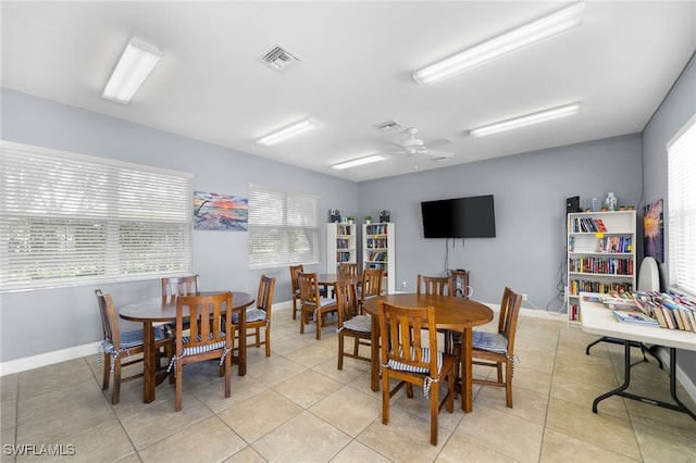 tiled dining area with ceiling fan