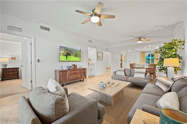 living room with ceiling fan, light tile patterned floors, and ornamental molding