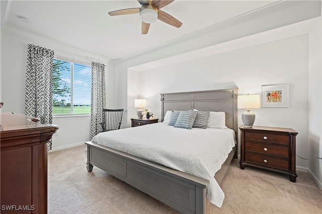 carpeted bedroom featuring ceiling fan and ornamental molding