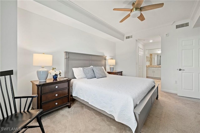 carpeted bedroom with ensuite bathroom, crown molding, and ceiling fan