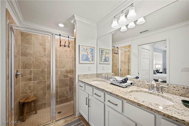 bathroom with vanity, crown molding, and walk in shower