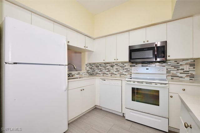 kitchen with white appliances, white cabinets, sink, tasteful backsplash, and light tile patterned flooring