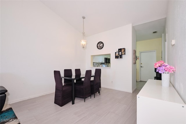 dining space with vaulted ceiling