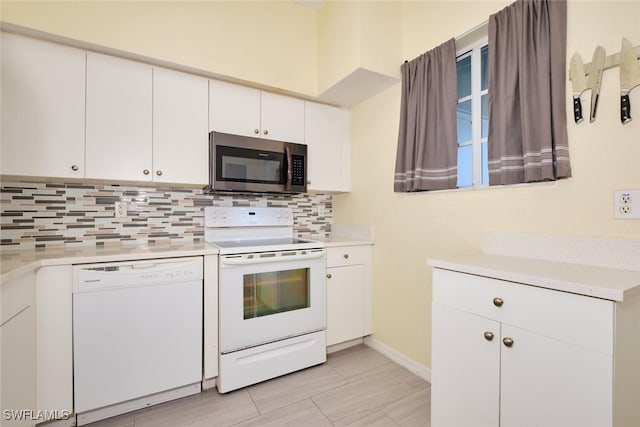 kitchen featuring backsplash, white cabinetry, and white appliances