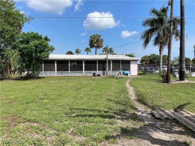 rear view of house featuring a yard