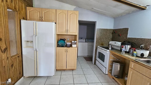 kitchen with light brown cabinets, white appliances, vaulted ceiling, independent washer and dryer, and tasteful backsplash