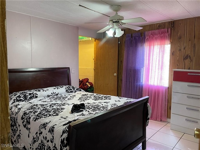 tiled bedroom with ceiling fan and wooden walls