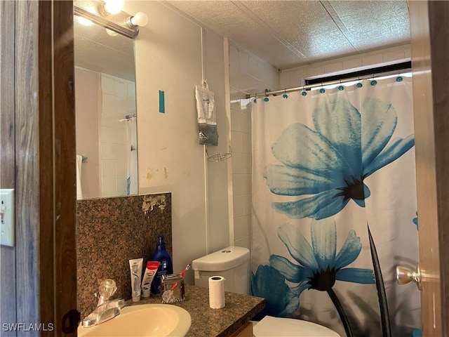 bathroom with vanity, a shower with shower curtain, a textured ceiling, and toilet