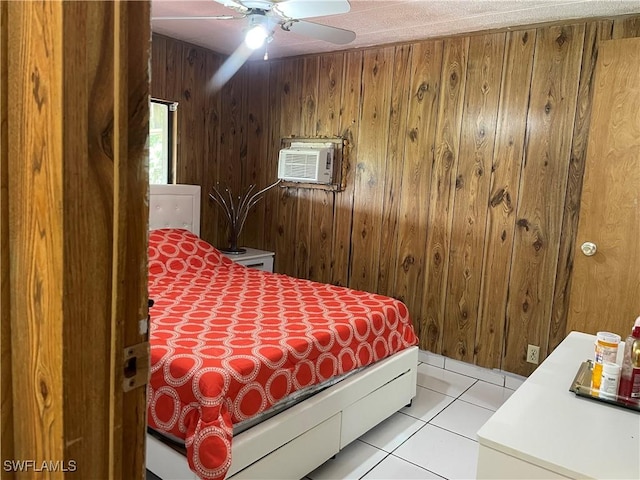 tiled bedroom featuring an AC wall unit, wood walls, and ceiling fan