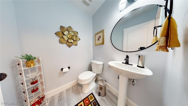 bathroom featuring toilet and hardwood / wood-style flooring