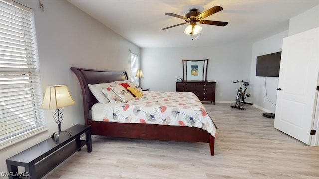 bedroom with ceiling fan and light hardwood / wood-style floors