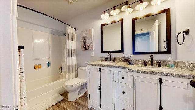 full bathroom featuring hardwood / wood-style flooring, toilet, vanity, and shower / tub combo